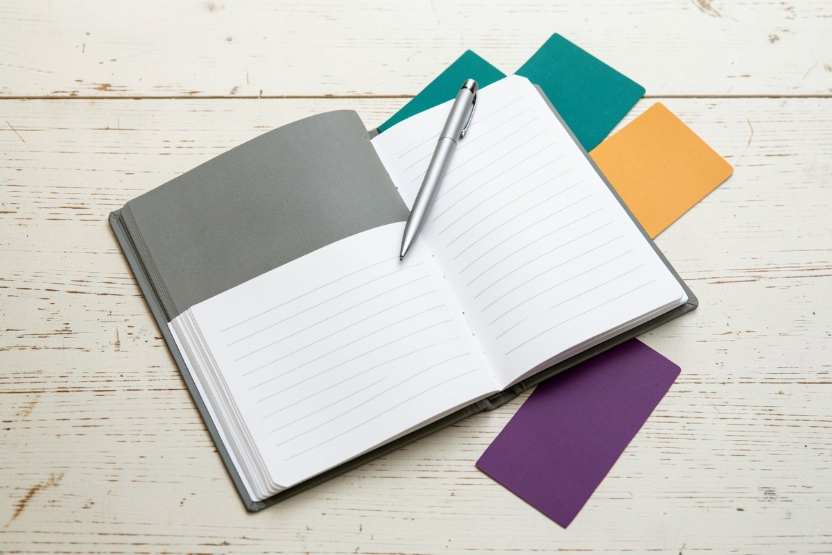 An open planner with a pen and a few credit cards spread out, illustrating different card categories.